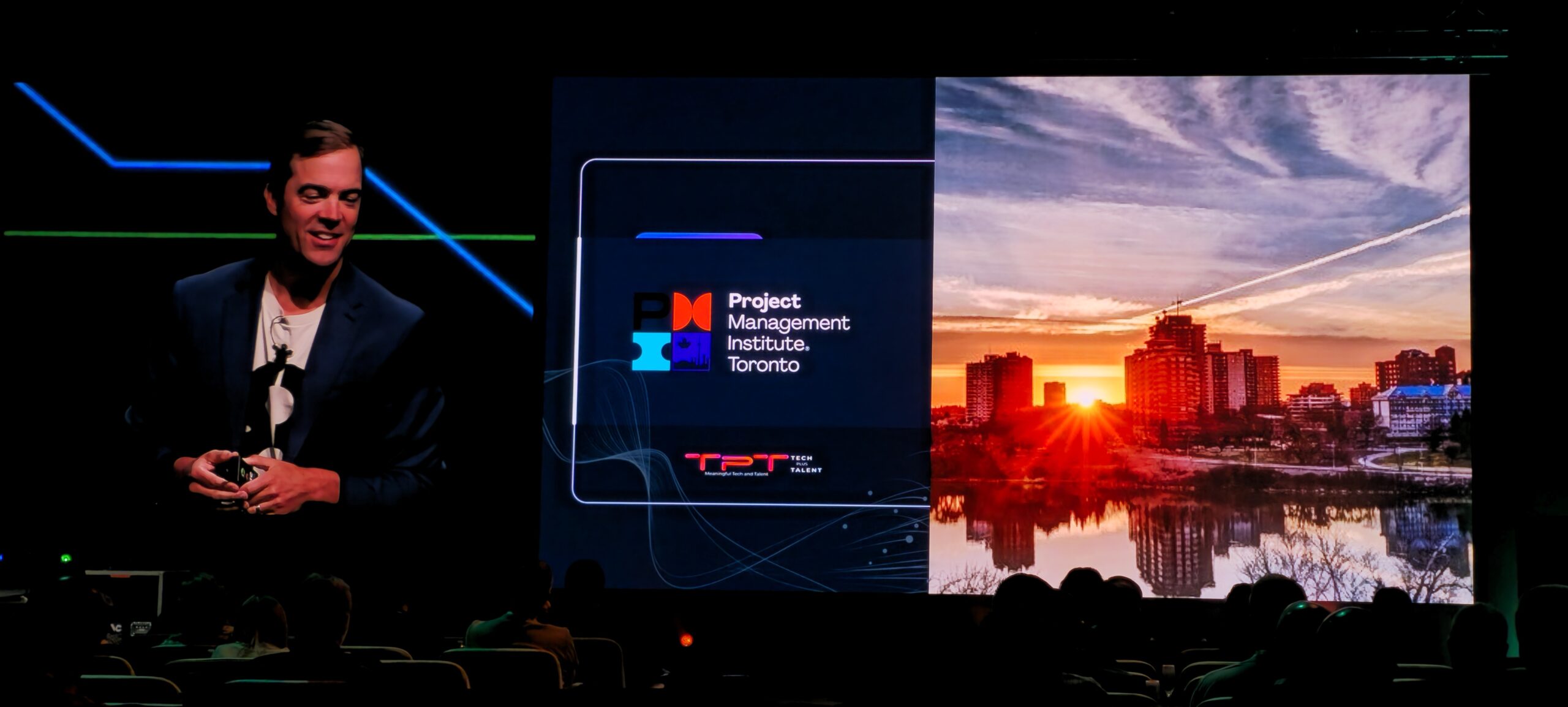Microsoft CVP Travis Walter on the conference stage, with the TechPlusTalent logo on screen